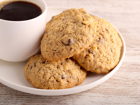 Oat chocolate chip cookies with cup of coffee