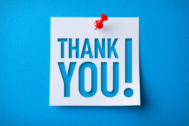 White Sticky Note With Thank You And Red Push Pin On Blue Cardboard