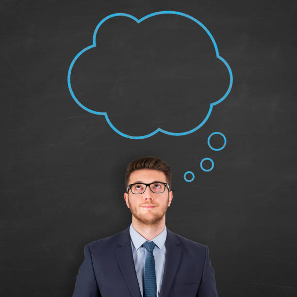 istock Business man standing next to thought bubble drawing on chalkboard. 2128295310