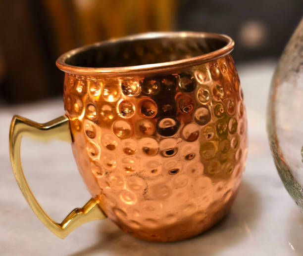istock Traditional iced tea served in a unique and artistic brass cup , ice tea garnished with rosemary twigs 2128303058
