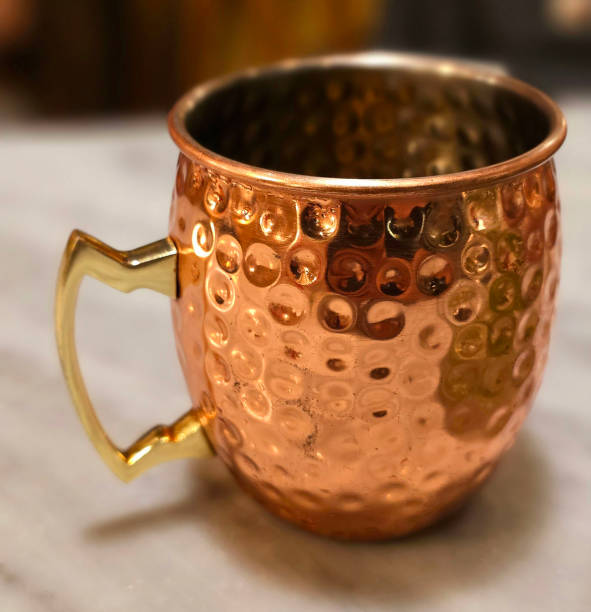 istock Traditional iced tea served in a unique and artistic brass cup , ice tea garnished with rosemary twigs 2128303070