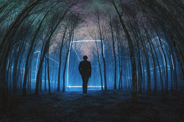 istock Man walking in mysterious forest at night 2128412359