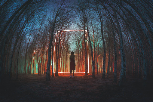 Woman walking in mysterious forest at night. 3D generated image.