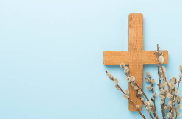 istock Cross with willow branches on color background, top, view. Palm Sunday concept 2128441552