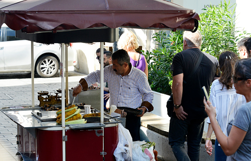 Istanbul, Turkey - September 7, 2022: Taksim Square - Street vendor of roasted corn