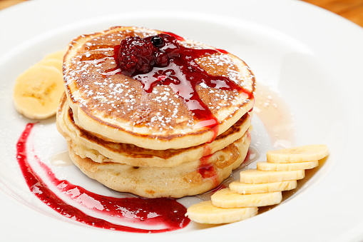 Pancake with banana and red berries