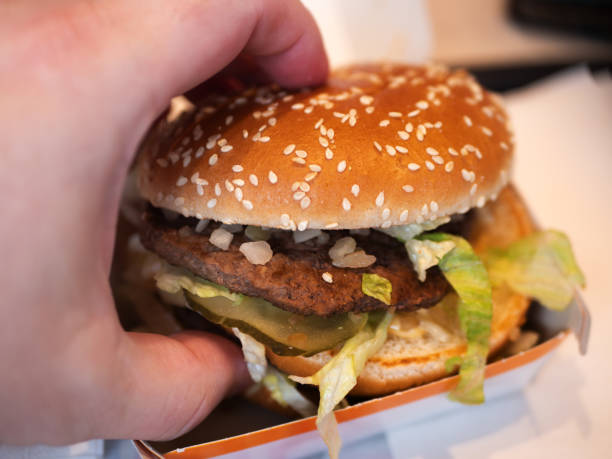 istock Juicy Cheeseburger with Lettuce and Sesame Seed Bun Close-Up 2128464932