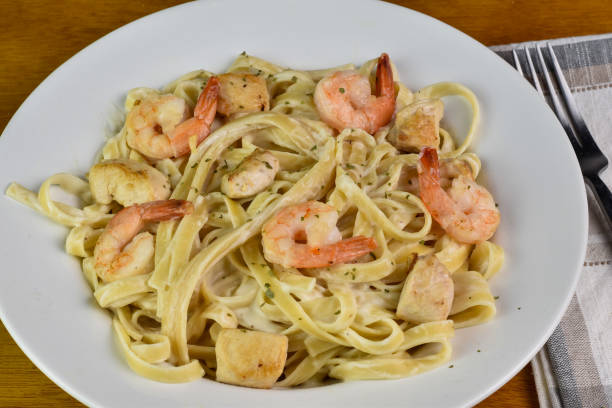 istock linguine  with alredo sauce  shrimp and chicken 2128527423