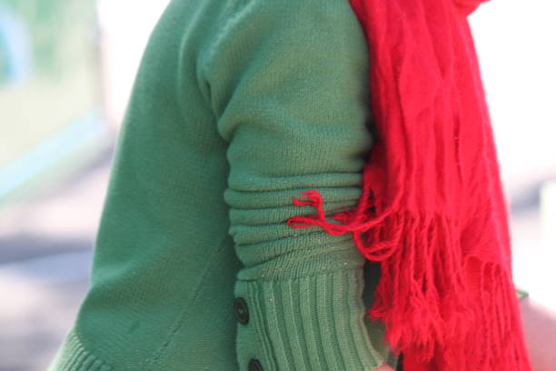 Person with Green Sweater and Red Scarf.