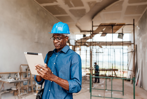 Engineer/investor using tablet at construction site