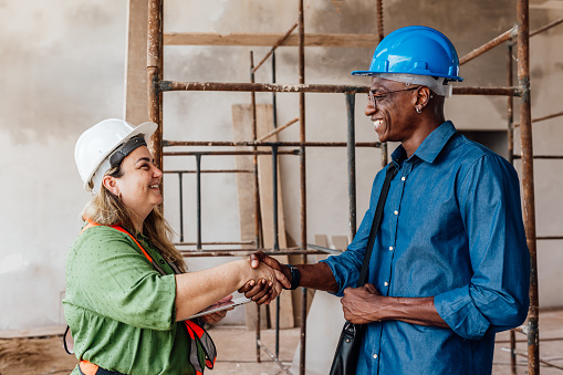 Female engineer shaking hands with a business consultant