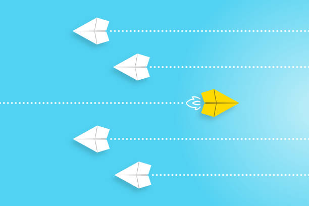 istock Leadership concepts with yellow paper airplane leading among white 2128579773