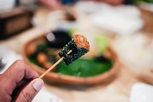 Pork skewers wrapped in fried betel leaves make a delicious appetizer.