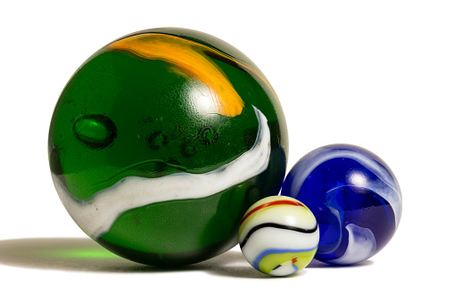 Three colorful marbles in three different sizes.