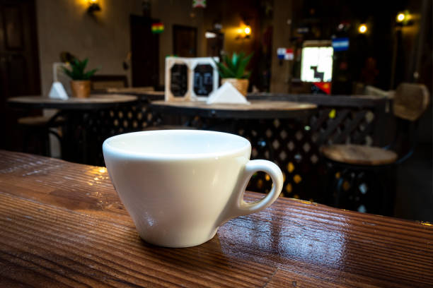 Coffee cup on the table. Cafe. Hot Coffee Cup on Wood Table in blurred Coffee Shop background.