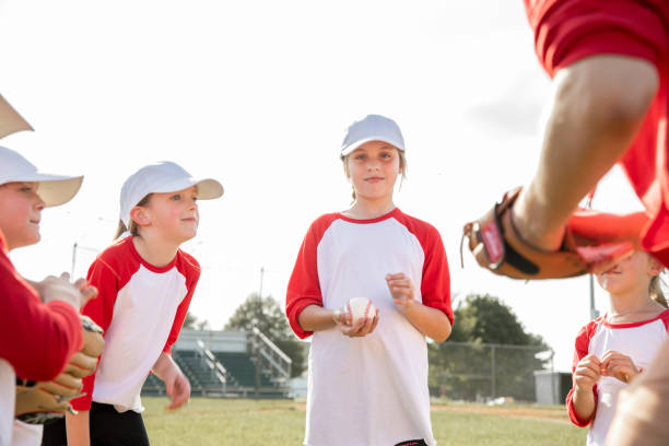 istock Co-ed little league baseball unites elementary school athletes and their coaches in a dynamic display of sportsmanship and teamwork on a ballfield 2128665965