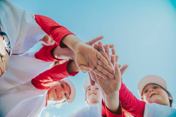Coached by dedicated mentors, elementary school children come together on a ballfield to showcase their skills in co-ed little league baseball