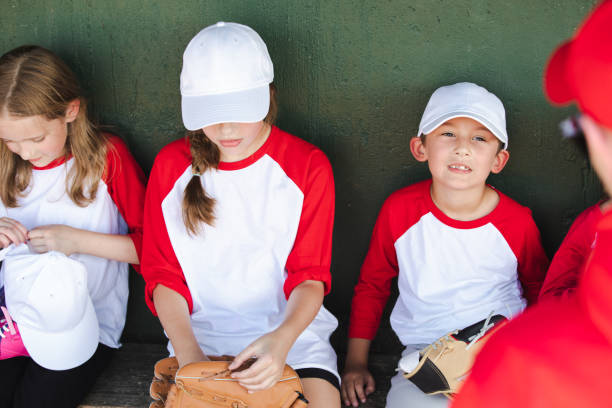 istock Within the dugout, a spirited group of six elementary school students, adorned in baseball team attire, congregates in anticipation 2128665974