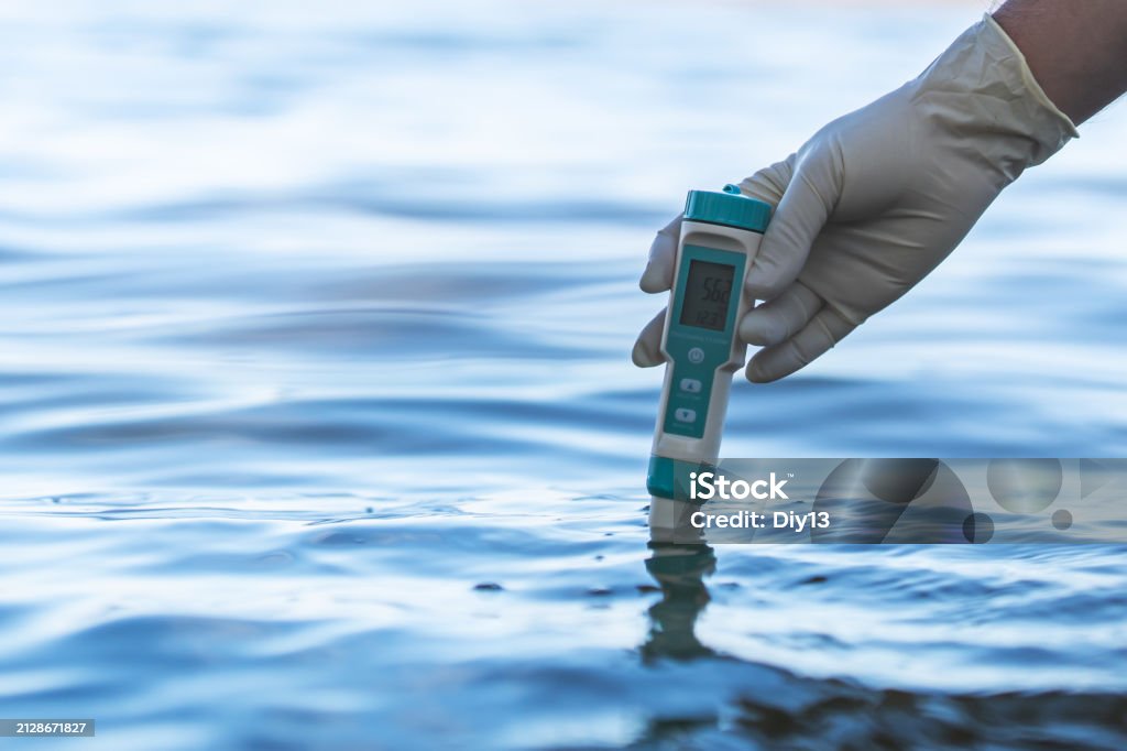 Water Testing Stock Electronic Water Testing Hand Over Blurred Blue Water Background Water ...