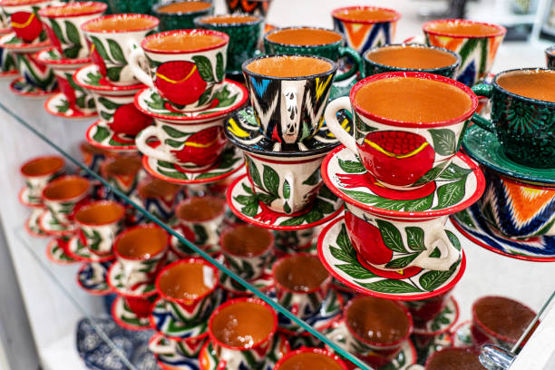 istock tea mugs with pomegranate pattern. Interesting hand painted ceramic cup with cotton ornament in Central Asian style. 2128675084
