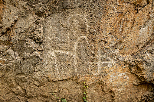 rock animals of deer of ancient people on a stone cliff. Charvak