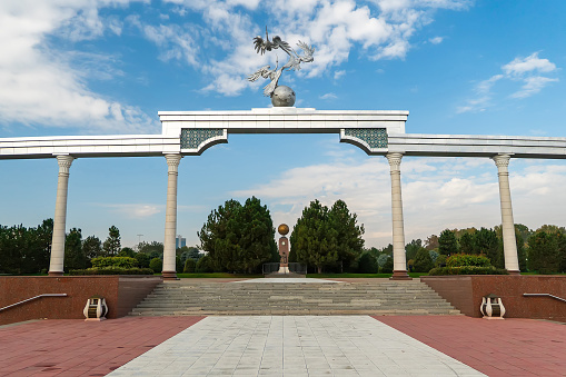 Storks flying over globe in the Ezgulik Arch of Good and Noble Aspirations at Independence square, Tashkent city in Uzbekistan