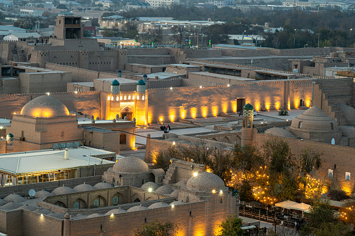 The ancient Zindan building and the entrance gate to the fortress in the city of Khiva in Khorezm. Kohna Ark gates of the palace at night, top view from above