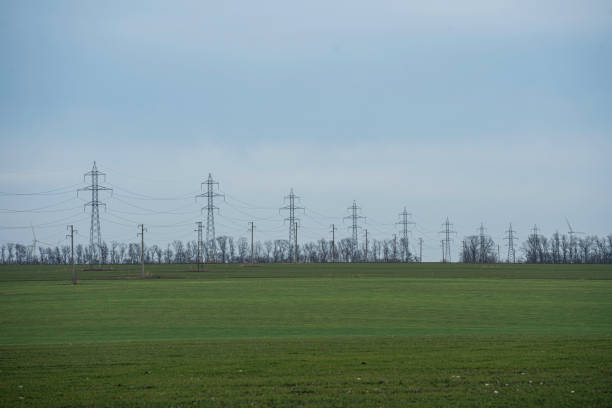 High voltage towers transport electric energy. Transmission of alternative and renewable energy.