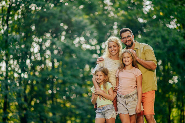 istock An affectionate family is hugging and posing in nature and smiling. 2128683281