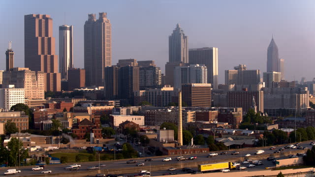 Corporate office buildings landscape: busy motorway connect Downtown with midtown Atlanta, GA. Aerial footage with panning camera motion