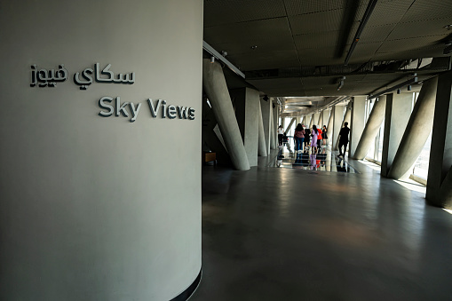 Dubai, UAE , United Arab Emirates. November 28th, 2022. View inside the Sky View skyscraper. Tourists walk on the glass floor and taking photos on a beautiful background