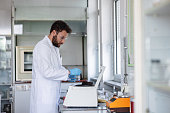 Latin Male Scientist Working With A Centrifuge At A Laboratory