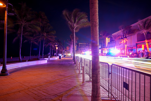 Fort Lauderdale, FL, USA - March 30, 2024: View of the sidewalk on A1A Fort Lauderdale night Spring Break