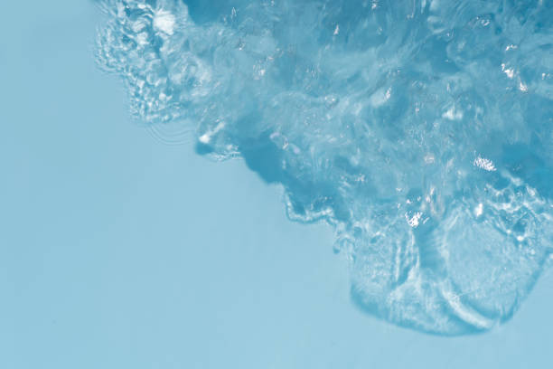 istock Blue water surface texture with ripples, splashes, and bubbles. Abstract summer banner background Water waves in sunlight with copy space cosmetic moisturizer micellar toner emulsion. Blue water wave. 2128774042