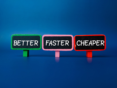 Colored wooden board with the word BETTER FASTER CHEAPER on blue background