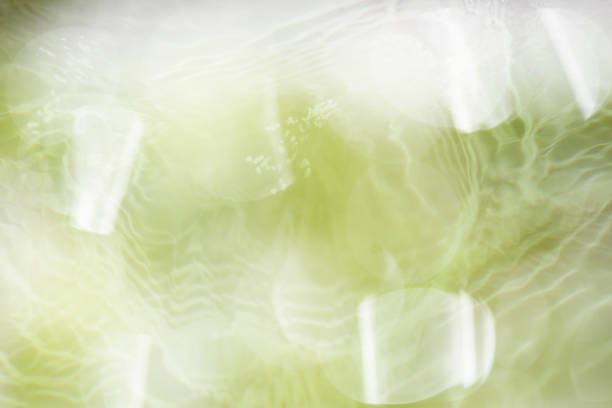 Blue water surface texture with ripples, splashes, and bubbles. Abstract summer banner background Water waves in sunlight with copy space cosmetic moisturizer micellar toner emulsion. Blue water wave.