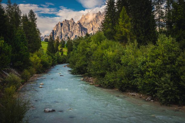 Winding Boite river and spectacular high mountains in background at sunset, Cortina d Ampezzo, Dolomites, Italy, Europe