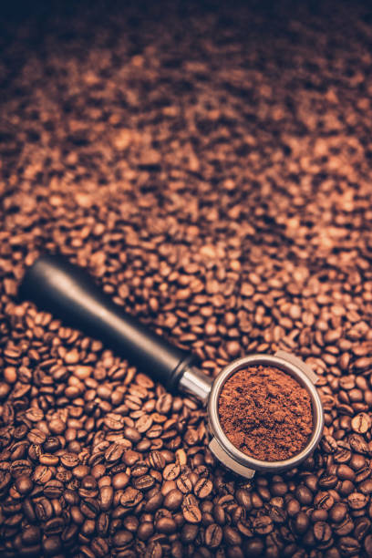 istock Roasted coffee beans with  filter holder 2128811811