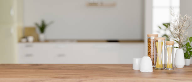 istock A space for display products on a wooden kitchen tabletop in a modern white kitchen. 2128908837