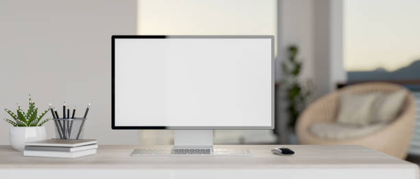 istock A modern white home office features a white-screen PC computer mockup and accessories on a desk. 2128908838