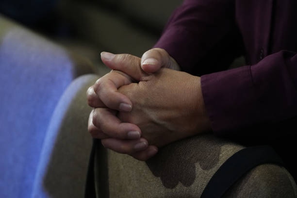 istock Human hands praying at Church. 2128924528