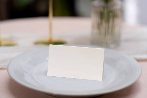 istock Mockup white blank space card, for Name place, Folded, greeting, invitation on wedding table setting background. 2129039645