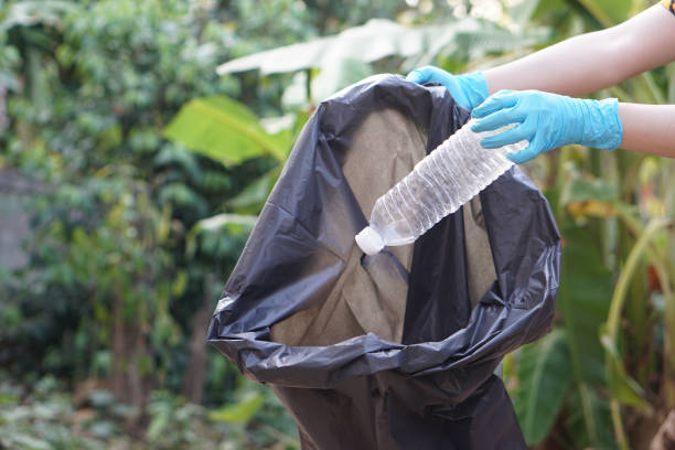istock Close up hands hold plastic bottle to put in black garbage bag. Concept, garbage management, reused, recycled plastic bottles. Keep clean and community service for the best environment. Zero waste. 2129116823