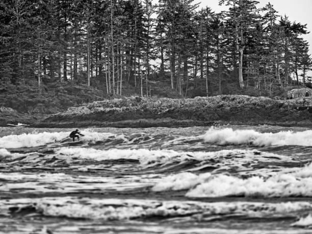 Waves and unrecognizable surfer off of the Pacific Rim National Park on Vancouver Island, British Columbia