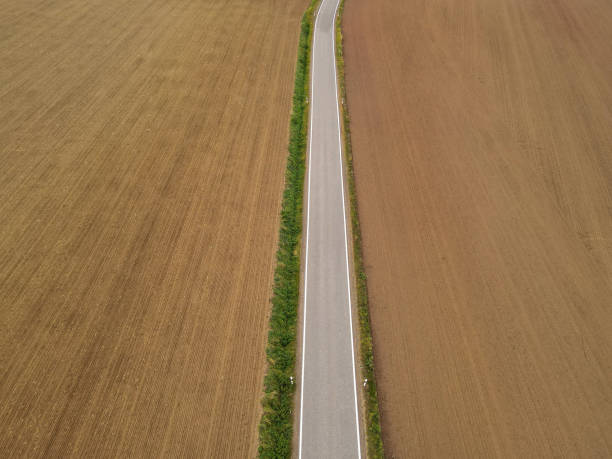 istock View from above of a paved road between farm fields in the countryside 2129173409