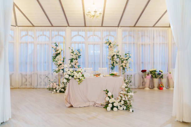 istock A table decorated with white flowers for a wedding celebration. 2129196476
