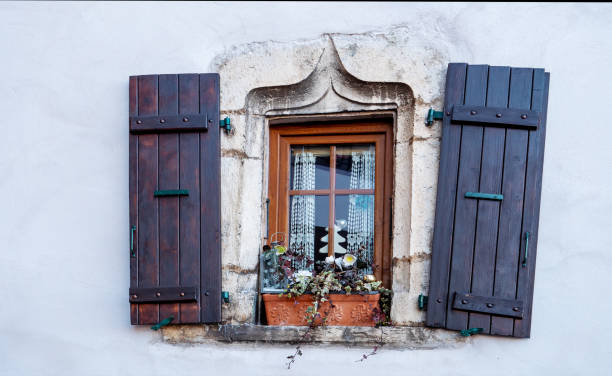 istock old wooden window on old wall. 2129221214