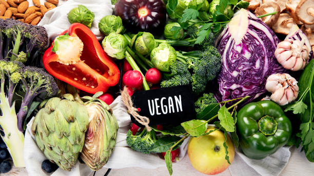 istock Table with vegetables on a light wood background. Pepper, cabbage, broccoli, radish, garlic. Healthy eating concept 2129221730