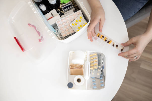 istock Closeup female hand placing medicament domestic first aid kit. Storage organization emergency supply 2129227733