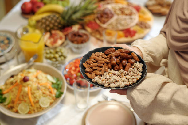 istock Hands Of Unrecognizable Muslim Woman Serving Festive Table 2129242128